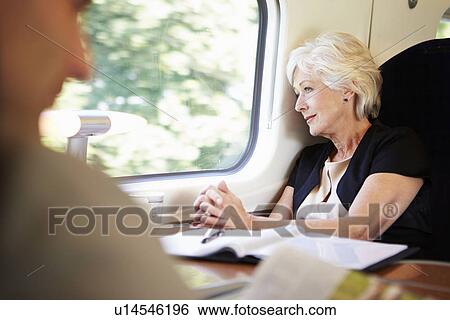 Stock Photograph - Businesswoman Relaxing On Train Journey. Fotosearch