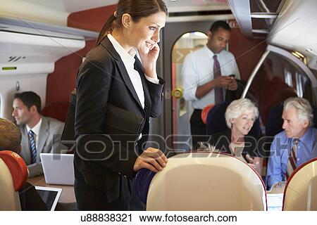 Businesswoman Using Mobile Phone On Busy Commuter Train View Large Photo Image Stock Image - Businesswoman Using Mobile Phone On Busy Commuter Train. Fotosearch