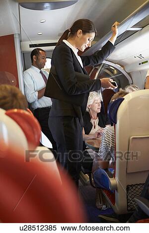 Businesswoman Using Mobile Phone On Busy Commuter Train View Large Photo Image Stock Photography - Businesswoman Using Mobile Phone On Busy Commuter Train. Fotosearch