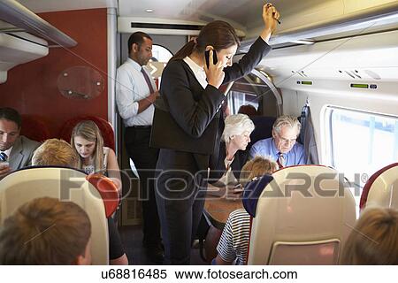 Businesswoman Using Mobile Phone On Busy Commuter Train View Large Photo Image Stock Photography - Businesswoman Using Mobile Phone On Busy Commuter Train. Fotosearch
