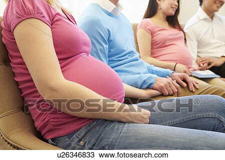 Stock Image - Couple Attending Ante Natal Class Together. Fotosearch