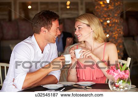 Stock Photo - Couple Enjoying Cup Of Coffee In Restaurant. Fotosearch
