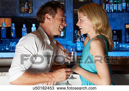 Couple Enjoying Drink In Bar View Large Photo Image Stock Image - Couple Enjoying Drink In Bar. Fotosearch
