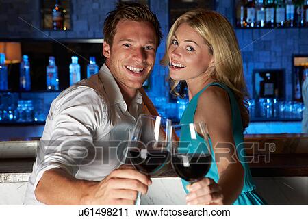 Couple Enjoying Drink In Bar View Large Photo Image Stock Image - Couple Enjoying Drink In Bar. Fotosearch