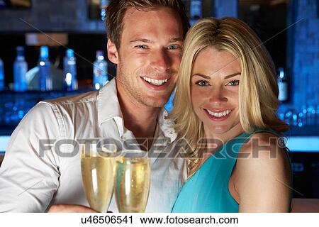 Couple Enjoying Glass Of Champagne In Bar View Large Photo Image Stock Image - Couple Enjoying Glass Of Champagne In Bar. Fotosearch