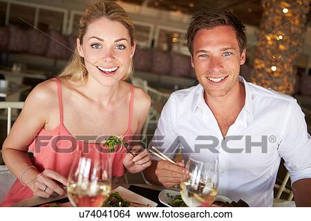 Picture - Couple Enjoying Meal In Restaurant. Fotosearch