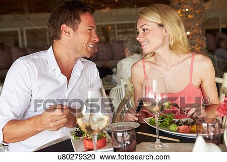 Couple Enjoying Meal In Restaurant View Large Photo Image Stock Image - Couple Enjoying Meal In Restaurant. Fotosearch