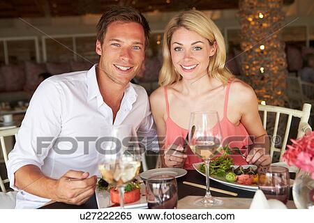 Stock Photography - Couple Enjoying Meal In Restaurant. Fotosearch