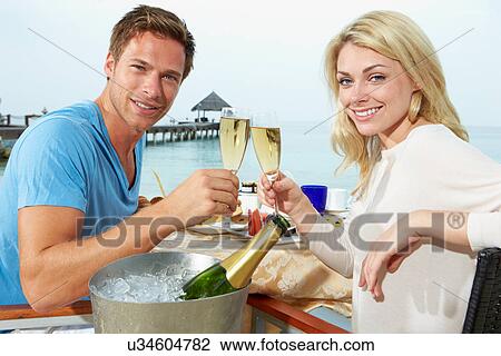 Couple Enjoying Meal In Seafront Restaurant View Large Photo Image Stock Image - Couple Enjoying Meal In Seafront Restaurant. Fotosearch