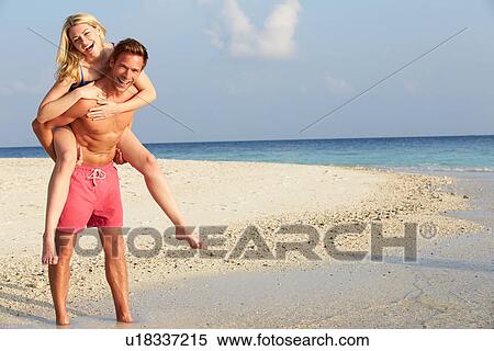Couple Having Fun On Tropical Beach Holiday View Large Photo Image Stock Photography - Couple Having Fun On Tropical Beach Holiday. Fotosearch