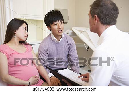 Couple Meeting With Obstetrician In Clinic View Large Photo Image Stock Photo - Couple Meeting With Obstetrician In Clinic. Fotosearch