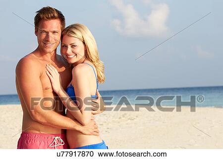 Stock Image - Couple On Tropical Beach Holiday. Fotosearch