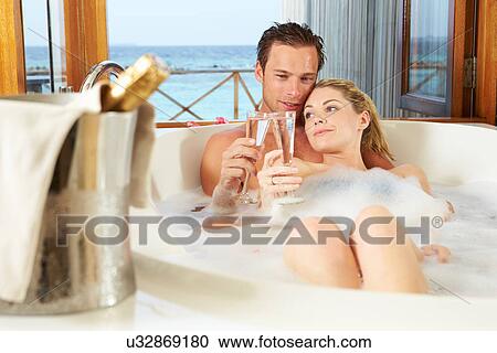 Couple Relaxing In Bath Drinking Champagne Together View Large Photo Image Stock Image - Couple Relaxing In Bath Drinking Champagne Together. Fotosearch