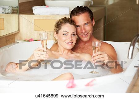 Couple Relaxing In Bath Drinking Champagne Together View Large Photo Image Stock Photo - Couple Relaxing In Bath Drinking Champagne Together. Fotosearch