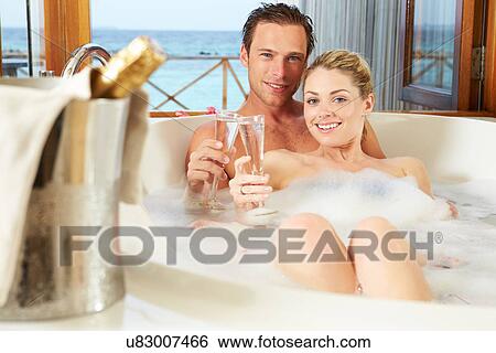 Couple Relaxing In Bath Drinking Champagne Together View Large Photo Image Stock Photograph - Couple Relaxing In Bath Drinking Champagne Together. Fotosearch