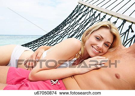 Couple Relaxing In Beach Hammock View Large Photo Image Picture - Couple Relaxing In Beach Hammock . Fotosearch