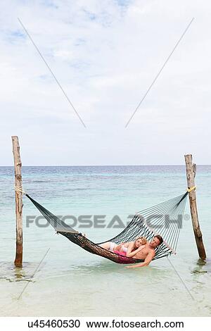 Couple Relaxing In Beach Hammock View Large Photo Image Stock Image - Couple Relaxing In Beach Hammock . Fotosearch