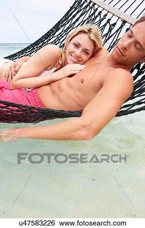 Couple Relaxing In Beach Hammock View Large Photo Image Stock Photograph - Couple Relaxing In Beach Hammock . Fotosearch
