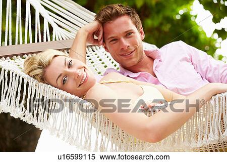Couple Relaxing In Beach Hammock View Large Photo Image Stock Photography - Couple Relaxing In Beach Hammock. Fotosearch