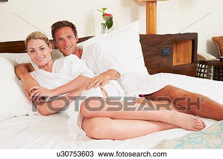 Couple Relaxing In Hotel Room Wearing Robes View Large Photo Image Stock Image - Couple Relaxing In Hotel Room Wearing Robes. Fotosearch