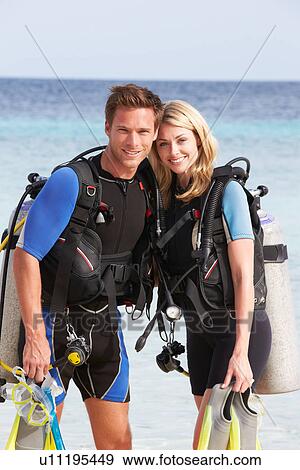 Stock Photo - Couple With Scuba Diving Equipment Enjoying Beach Holiday. Fotosearch