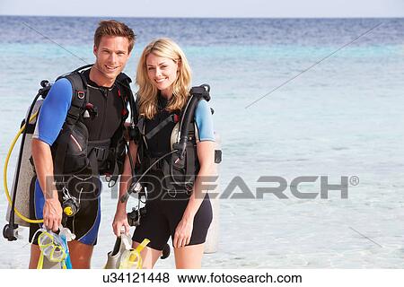 Couple With Scuba Diving Equipment Enjoying Beach Holiday View Large Photo Image Stock Photo - Couple With Scuba Diving Equipment Enjoying Beach Holiday. Fotosearch