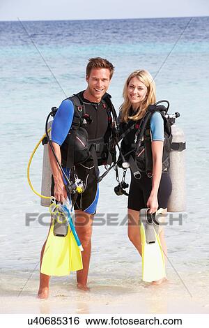 Couple With Scuba Diving Equipment Enjoying Beach Holiday View Large Photo Image Stock Photograph - Couple With Scuba Diving Equipment Enjoying Beach Holiday. Fotosearch