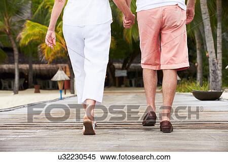 Detail Of Senior Couple Walking On Wooden Jetty View Large Photo Image Stock Photography - Detail Of Senior Couple Walking On Wooden Jetty. Fotosearch