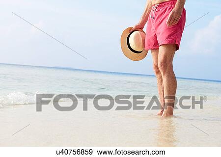 Detail Of Senior Man Standing In Sea On Beach Holiday View Large Photo Image Stock Photo - Detail Of Senior Man Standing In Sea On Beach Holiday. Fotosearch