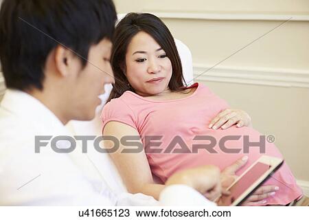 Doctor Using Digital Tablet In Meeting With Pregnant Woman View Large Photo Image Stock Image - Doctor Using Digital Tablet In Meeting With Pregnant Woman. Fotosearch