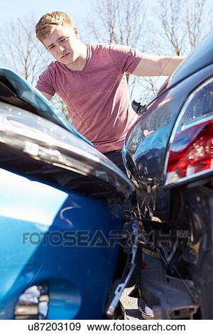 Stock Photo - Driver Inspecting Damage After Traffic Accident. Fotosearch