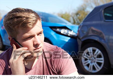 Stock Image - Driver Making Phone Call After Traffic Accident. Fotosearch