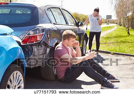 Stock Image - Driver Making Phone Call After Traffic Accident. Fotosearch