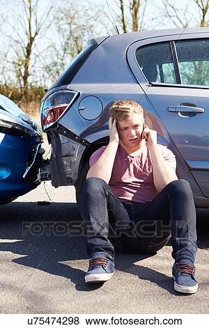 Stock Photo - Driver Making Phone Call After Traffic Accident. Fotosearch