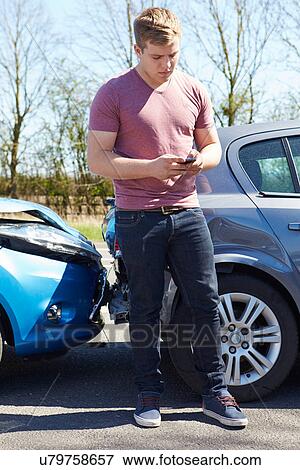 Stock Photo - Driver Making Phone Call After Traffic Accident. Fotosearch