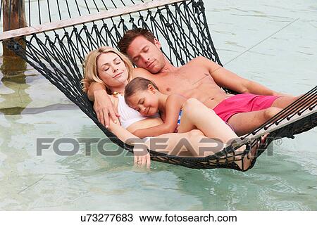 Family Relaxing In Beach Hammock View Large Photo Image Stock Image - Family Relaxing In Beach Hammock . Fotosearch