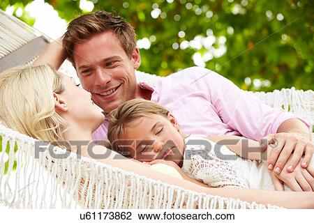 Family Relaxing In Beach Hammock With Sleeping Daughter View Large Photo Image Stock Image - Family Relaxing In Beach Hammock With Sleeping Daughter. Fotosearch