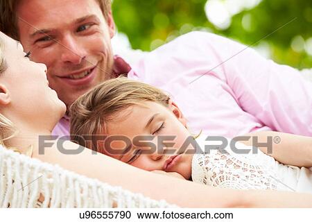 Family Relaxing In Beach Hammock With Sleeping Daughter View Large Photo Image Stock Image - Family Relaxing In Beach Hammock With Sleeping Daughter. Fotosearch