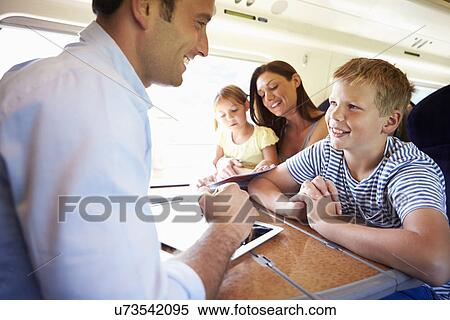 Family Relaxing On Train Journey View Large Photo Image Stock Photography - Family Relaxing On Train Journey. Fotosearch