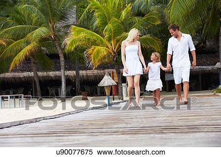 Stock Photography - Family Walking On Wooden Jetty. Fotosearch