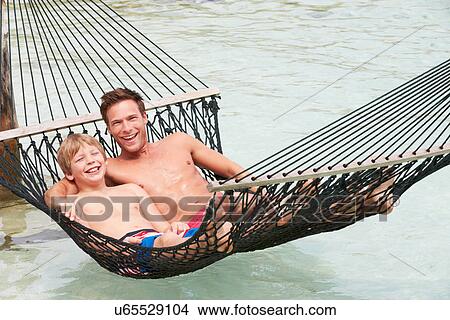 Father And Son Relaxing In Beach Hammock View Large Photo Image Picture - Father And Son Relaxing In Beach Hammock . Fotosearch
