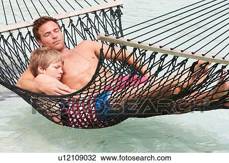 Father And Son Relaxing In Beach Hammock View Large Photo Image Stock Image - Father And Son Relaxing In Beach Hammock . Fotosearch