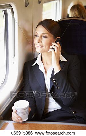 Female Commuter With Coffee On Train Using Mobile Phone View Large Photo Image Stock Photograph - Female Commuter With Coffee On Train Using Mobile Phone . Fotosearch