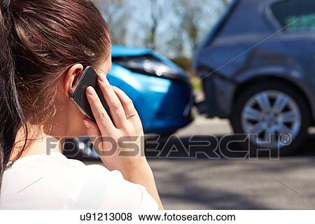Stock Photo - Female Driver Making Phone Call After Traffic Accident. Fotosearch