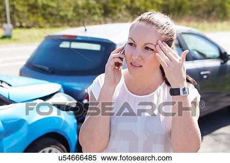 Stock Photography - Female Driver Making Phone Call After Traffic Accident. Fotosearch