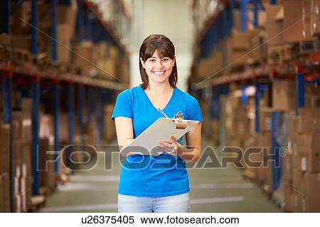 Stock Photography - Female Worker In Distribution Warehouse. Fotosearch