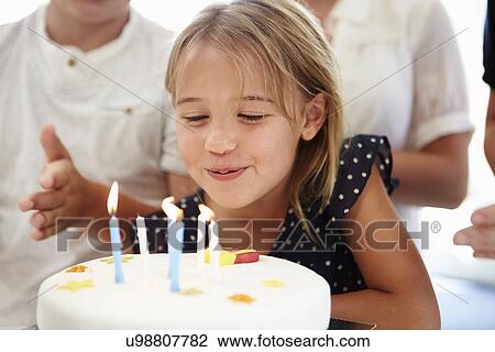 Stock Image - Girl Celebrating Birthday With Cake. Fotosearch
