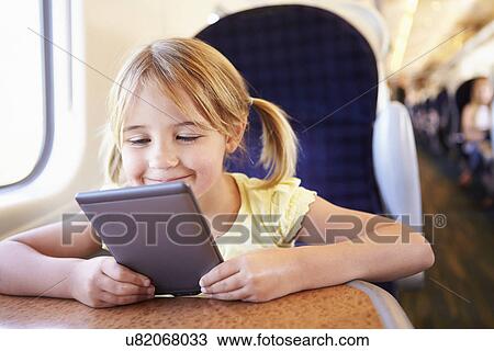 Girl Reading E Book On Train View Large Photo Image Stock Image - Girl Reading E Book On Train. Fotosearch