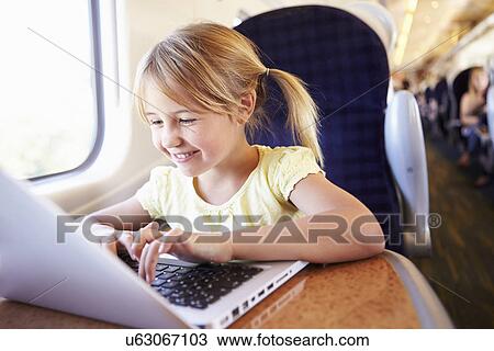 Girl Using Laptop On Train View Large Photo Image Stock Image - Girl Using Laptop On Train. Fotosearch
