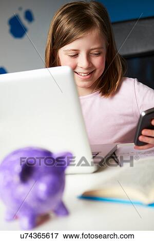 Stock Photo - Girl Using Mobile Phone Instead Of Studying In Bedroom . Fotosearch